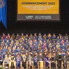 Graduates sit on stage at the 2023 commencement for the Betty Irene Moore School of Nursing